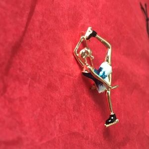Gold tone female ice skater brooch